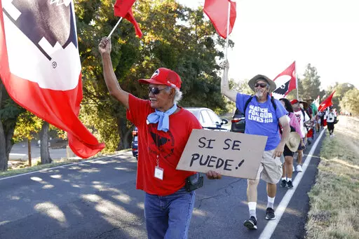 Asunción Ponce, left, marches with fellow members of the United Farm Workers in support of a bill that would allow farmworkers to vote by mail in union elections, near Walnut Grove, Calif., Wednesday, Aug. 24, 2022. Gov. Gavin Newsom, on Wednesday, Sept. 28, 2022, signed the measure. (Jessica Christian/San Francisco Chronicle via AP, File)
