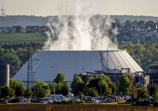 Smoke rises from the nuclear power plant of Nerckarwestheim in Neckarwestheim, Germany, on Aug. 22, 2022. Europe is staring an energy crisis in the face. The cause: Russia throttling back supplies of natural gas. European officials say it's a pressure game over their support for Ukraine after Russia's invasion. (AP Photo/Michael Probst, File)