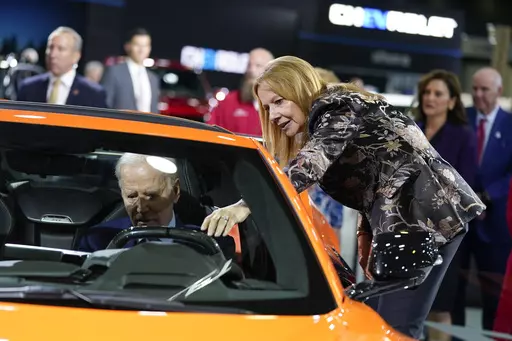 Mary Barra, CEO of General Motors, talks with President Joe Biden as he sits in a Corvette during a tour of the Detroit Auto Show on Sept. 14, 2022, in Detroit. United Auto Workers President Shawn Fain's focus on CEO pay is part of a growing trend as emboldened labor unions cite the widening wealth gap between workers and the top bosses to bolster their demand for higher wages and better working conditions. (AP Photo/Evan Vucci, File)