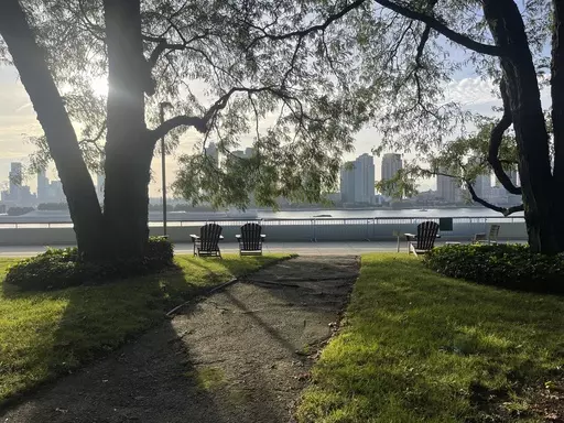 Chairs for contemplation look out upon the East River inside the U.N. compound in New York on Friday, Sept. 22, 2023. The parklet in the U.N. compound is a place where people go to find a few minutes of peace just yards from the buildings where leaders and diplomats deal with the world’s chaos. (AP Photo/Ted Anthony)