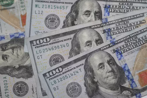 This Jan. 22, 2020, file photo shows the likeness of Benjamin Franklin on $100 bills in Dallas. Realizing that financial stress is common can be the first step toward reducing it, money experts say. Thinking you are the only one experiencing it can compound those negative feelings. Checking in with your body, so you notice when you’re having a fight-or-flight response to financial decisions, can also help. (AP Photo/LM Otero, File)