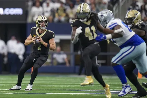 New Orleans Saints quarterback Derek Carr looks to pass against the Dallas Cowboys during the first half of an NFL football game, Sunday, Sept. 15, 2024, in Arlington, Texas. (AP Photo/Jeffrey McWhorter)