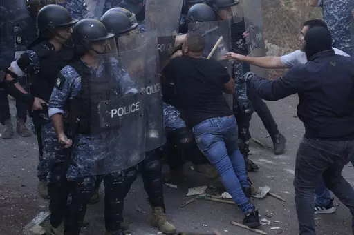 Lebanese-Armenian protesters clash with riot police near the Azerbaijani Embassy, during a protest to denounce the Azerbaijani military offensive that recaptured Nagorno-Karabakh from the separatist Armenian authorities in the enclave, in Ain Aar, east of Beirut, Lebanon, Thursday, Sept. 28, 2023. A 24-hour Azerbaijani blitz last week forced Armenian separatist authorities to sit down for talks on Nagorno-Karabakh's "reintegration" into Azerbaijan. (AP Photo/Hussein Malla)