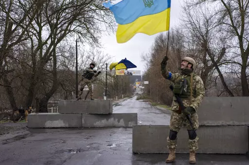 Ukrainian soldiers celebrate at a check point in Bucha, in the outskirts of Kyiv, Ukraine, April 3, 2022. Kyiv was a Russian defeat for the ages. It started poorly for the invaders and went downhill from there.  (AP Photo/Rodrigo Abd, File)