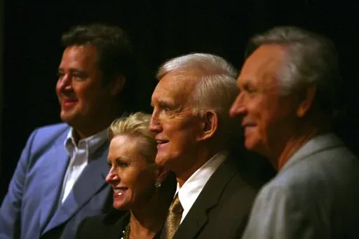 Tammy Genovese, second left, Country Music Association Chief Operating Officer, poses for a photo with Vince Gill, left, Ralph Emery and Mel Tillis, right, Tuesday, Aug. 7, 2007, in Nashville, Tenn., after it was announced that the three men will be inducted into the Country Music Hall of Fame. Emery, who became known as the dean of country music broadcasters over more than a half-century in both radio and television, died Saturday, Jan. 15, 2022, his family said. He was 88. (AP Photo/Jeff Adkin