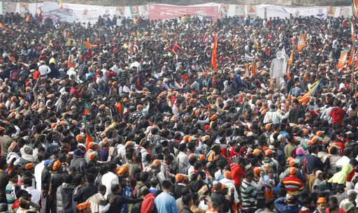 A crowd of supporters gather to listen to Indian Prime Minister Narendra Modi as he lays the foundation stone of Major Dhyan Chand Sports University in Meerut, Uttar Pradesh state on Jan. 2, 2022. Coronavirus cases fueled by the highly transmissible omicron variant have rocketed through India and the country is scrambling to ward off its impact by swiftly introducing a string of restrictions that the population thought were history. But India’s political leaders, including Modi, have largely f