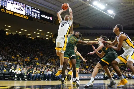 Iowa forward Filip Rebraca (0) drives to the basket ahead of Southeastern Louisiana guard Gus Okafor (35) during the second half of an NCAA college basketball game, Tuesday, Dec. 21, 2021, in Iowa City, Iowa. Iowa won 93-62. (AP Photo/Charlie Neibergall)