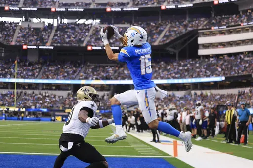Los Angeles Chargers wide receiver Ladd McConkey (15) pulls in a touchdown reception over New Orleans Saints safety Ugo Amadi (0) in the second half of an NFL football game in Inglewood, Calif., Sunday, Oct. 27, 2024. (AP Photo/Ryan Sun)