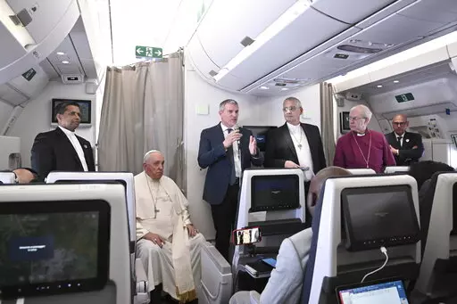 The Archbishop of Canterbury Justin Welby, right, Pope Francis,left, and the Moderator of the General Assembly of the Church of Scotland Iain Greenshields meet the journalists during an airborne press conference aboard the airplane directed to Rome, at the end of his pastoral visit to Congo and South Sudan, Sunday, Feb. 5, 2023. (Tiziana Fabi/Pool Photo Via AP)