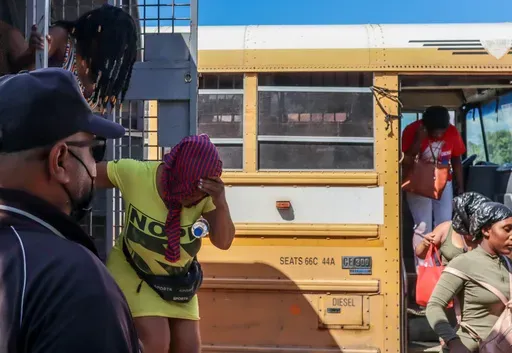 Haitians deported from the Dominican Republic get out of trucks in Carrizal, Dominican Republic, on the border with Haiti, Thursday, Jan. 30, 2025. (AP Photo/Martin Adames)