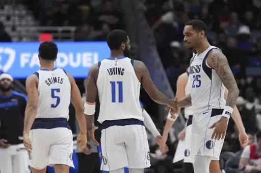 Dallas Mavericks forward P.J. Washington (25) celebrates his 3-point shot with guard Kyrie Irving (11) in the second half of an NBA basketball game against the New Orleans Pelicans in New Orleans, Wednesday, Jan. 29, 2025. (AP Photo/Gerald Herbert)