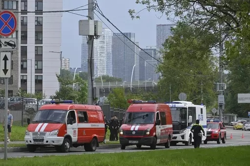 Police and emergency vehicles parked at the side of the wreckage of the drone fell near the Karamyshevskaya embankment to the after a reported drone attack in Moscow, Russia, on Friday, Aug. 11, 2023. The Mayor of Moscow, Sergei Sobyanin said a drone fell in western Moscow after it was shot down by air defense systems. Sobyanin said no-one was hurt when the drone fell near Karamyshevskaya embankment and that no serious damage was caused. Russian social media channels shared videos of what they s