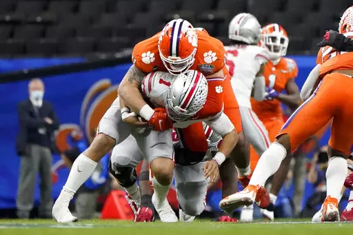 Ohio State quarterback Justin Fields is sacked by Clemson defensive lineman Bryan Bresee during the second half of the Sugar Bowl NCAA college football game in New Orleans, Jan. 1, 2021. Bresee was named to the Associated Press preseason All-America team, Monday, Aug. 22, 2022. (AP Photo/Gerald Herbert, File)