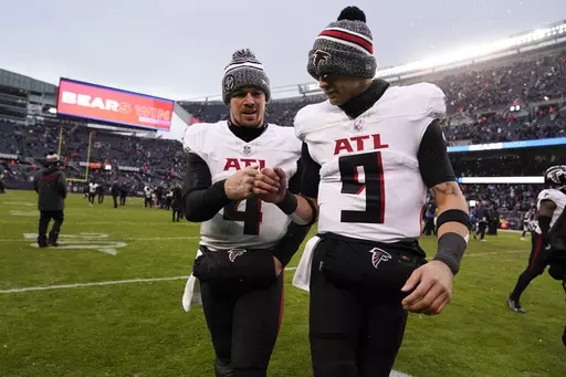 Atlanta Falcons quarterback Taylor Heinicke (4) and Atlanta Falcons quarterback Desmond Ridder (9) walk off the field after a loss to the Chicago Bears after an NFL football game in Chicago, Sunday, Dec. 31, 2023. (AP Photo/Charles Rex Arbogast)