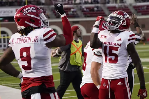 Louisiana-Lafayette tight end Neal Johnson (9) clebrates his touchdown with Robert Williams (15) during the second half of an NCAA college football game against Troy, Saturday, Nov. 18, 2023, in Troy, Ala. (AP Photo/Mike Stewart)