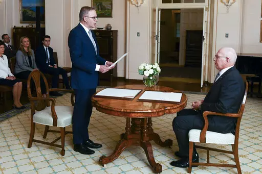 Anthony Albanese is sworn in as Australia's Prime Minister by Australian Governor-General David Hurley, right, during a ceremony at Government House in Canberra, Monday, May 23, 2022. Albanese has been sworn in ahead of a Tokyo summit while vote counting continues to decide whether he will control a majority in a Parliament that is demanding tougher action on climate change. (Lukas Coch/AAP Image via AP)