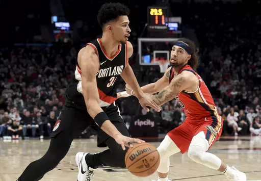 Portland Trail Blazers forward Toumani Camara, left, drives against New Orleans Pelicans guard Jose Alvarado during the first half of an NBA basketball game in Portland, Ore., Saturday Feb. 10, 2024. (AP Photo/Steve Dykes)