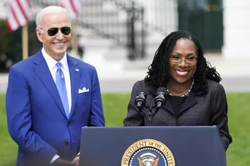 President Joe Biden listens as Judge Ketanji Brown Jackson speaks during an event on the South Lawn of the White House in Washington, April 8, 2022, celebrating the confirmation of Jackson as the first Black woman to reach the Supreme Court. Overall, 48% of Americans say they approve and 19% disapprove of Jackson’s confirmation to the high court according to the new poll from The Associated Press-NORC Center for Public Affairs Research. The remaining 32% of Americans hold no opinion. (AP Photo