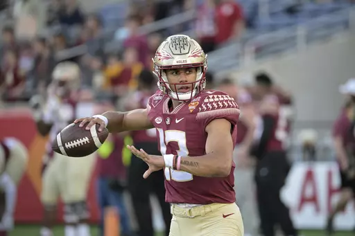 Florida State quarterback Jordan Travis (13) warms up before the Cheez-It Bowl NCAA college football game against Oklahoma, Thursday, Dec. 29, 2022, in Orlando, Fla. Florida State opens their season at home against LSU on Sept. 3. (AP Photo/Phelan M. Ebenhack, File)