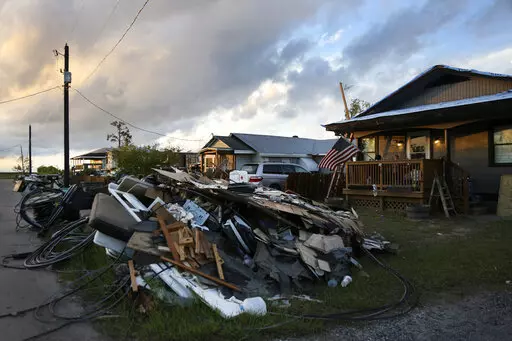 Debris and electrical wires are piled up in a front yard in Chauvin, La., on Sept. 27, 2021. $45 million funding bill to address soaring homeowner insurance rates in hurricane-battered Louisiana was up for debate Friday, Feb. 3, 2023 in the state's Senate. (AP Photo/Jessie Wardarski, File)