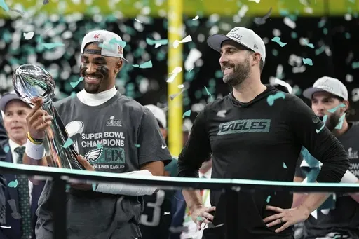 Philadelphia Eagles quarterback Jalen Hurts, left, holds the Vince Lombardi Trophy next to head coach Nick Sirianni after defeating the Kansas City Chiefs in the NFL Super Bowl 59 football game, Sunday, Feb. 9, 2025, in New Orleans. (AP Photo/Matt Slocum)