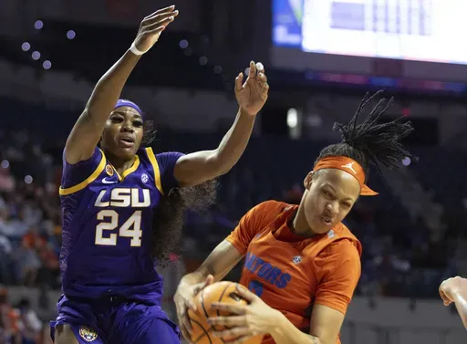 Florida guard Me'Arah O'Neal, right, rebounds past LSU guard Aneesah Morrow (24) during the first half an NCAA college basketball game Sunday, Jan. 19, 2025, in Gainesville, Fla. (AP Photo/Alan Youngblood)