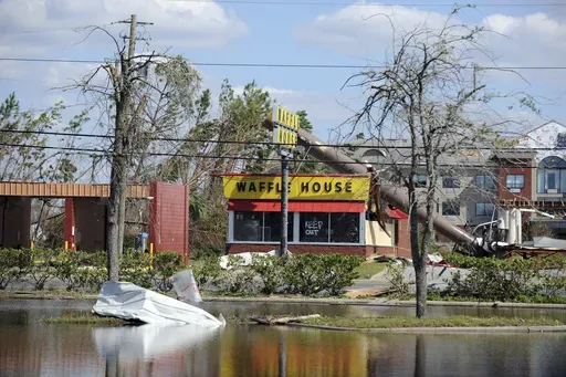 A billboard lies atop a Waffle House restaurant after being knocked down by Hurricane Michael in Panama City, Fla., Oct. 14, 2018. (Carlos R. Munoz/Sarasota Herald-Tribune via AP, File)