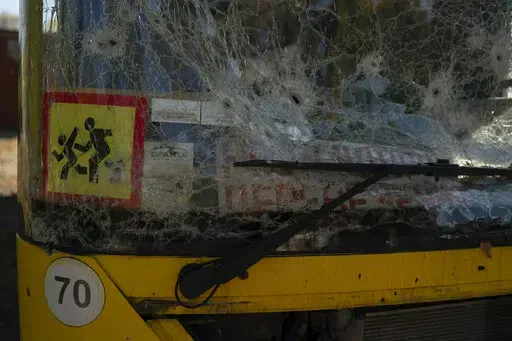 A damaged school bus is seen in the retaken village of Velyka Oleksandrivka, Ukraine, Wednesday, Oct. 12, 2022. (AP Photo/Leo Correa)
