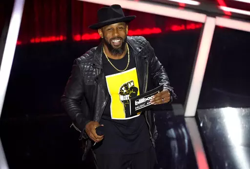 Stephen "tWitch" Boss presents the award for top Latin artist at the Billboard Music Awards in Los Angeles on Oct. 14, 2020. (AP Photo/Chris Pizzello, File)