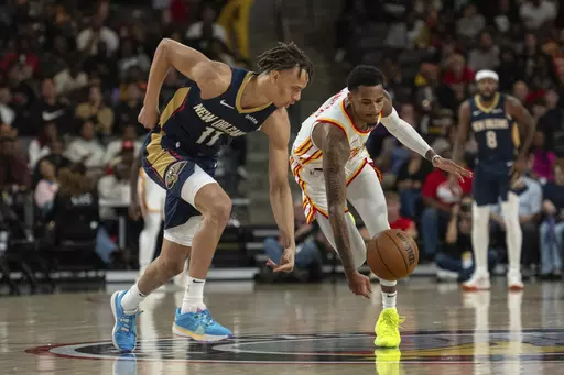 CORRECTS TO 2023 NOT 2022 - New Orleans Pelicans guard Dyson Daniels (11) knocks the ball away from Atlanta Hawks guard Dejounte Murray, front right, during the first half of a preseason NBA basketball game Saturday, Oct. 14, 2023, in College Park, Ga. (AP Photo/Hakim Wright Sr.)