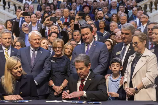 Gov. Brian Kemp signs an antisemitism bill HB 30 at the Capitol in Atlanta, on Wednesday, Jan. 31, 2024. (Arvin Temkar/Atlanta Journal-Constitution via AP)