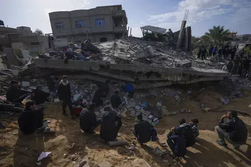Palestinians search for bodies and survivors in the rubble of a residential building destroyed in an Israeli airstrike in Rafah, Gaza Strip, on March 4, 2024. An AP analysis of Gaza Health Ministry data finds the proportion of Palestinian women and children being killed in the Israel-Hamas war appears to have declined sharply. Israel faces heavy international criticism over unprecedented levels of civilian casualties in Gaza. (AP Photo/Fatima Shbair, File)