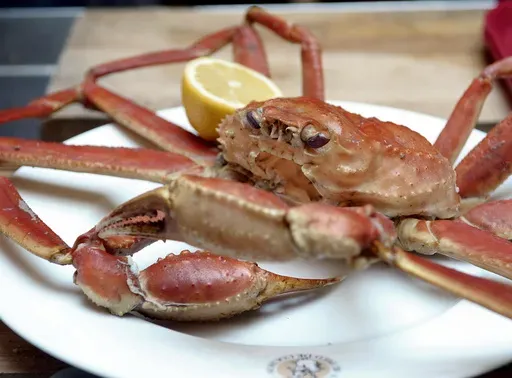 Snow Crab with lemon sits on a plate at the Au Pied De Cochon restaurant, April 18, 2008, in Montreal. (AP Photo/The Canadian Press, Graham Hughes, File)