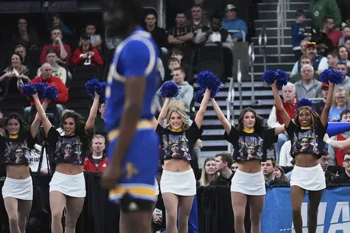 McNeese State cheerleaders wear t-shirts highlighting team student manager Amir Kahn during the first half in the second round of the NCAA college basketball tournament, Saturday, March 22, 2025, in Providence, R.I. (AP Photo/Charles Krupa)