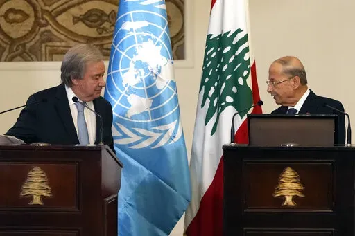 Lebanese President Michel Aoun, right, speaks during a joint press conference with United Nations Secretary-General Antonio Guterres at the presidential palace in Baabda east of Beirut, Lebanon, Sunday, Dec. 19, 2021. (AP Photo/Hassan Ammar)