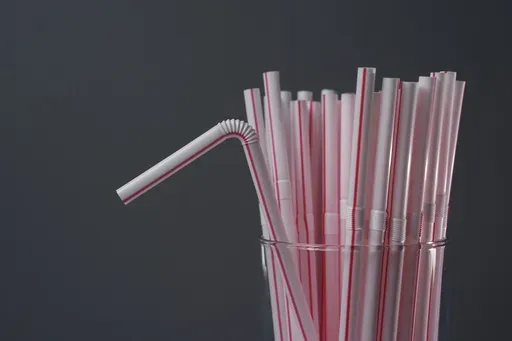 Plastic straws are displayed in a glass, Tuesday, Feb. 11, 2025, in Cincinnati. (AP Photo/Joshua A. Bickel)