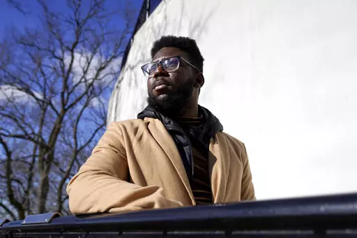 Somerville City Councilor Willie Burnley Jr., stands near the Prospect Hill Monument, Wednesday, Feb. 1, 2023, in Somerville, Mass. Somerville could follow the lead of an increasing number of municipal, county and state governments and use federal pandemic relief funds to pay residents' burdensome medical debt. (AP Photo/Steven Senne)