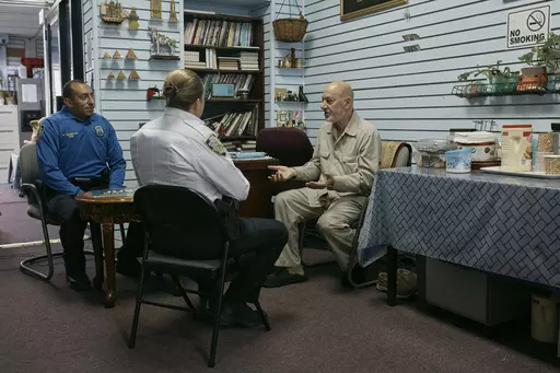 Police talks to Zein Ramawi, right, leader of the Islamic Society of Bay Ridge mosque, at An-Noor Social Center on Friday, Oct. 13, 2023, in the Brooklyn borough of New York. In Muslim communities across the world, worshippers gathered at mosques for their first Friday prayers since Hamas militants attacked Israel, igniting the latest Israel-Palestinian war. (AP Photo/Andres Kudacki)