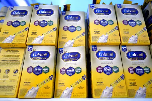 Infant formula is stacked on a table during a baby formula drive to help with the shortage May 14, 2022, in Houston.  President Joe Biden has invoked the Defense Production Act to speed production of infant formula and has authorized flights to import supply from overseas. (AP Photo/David J. Phillip, File)
