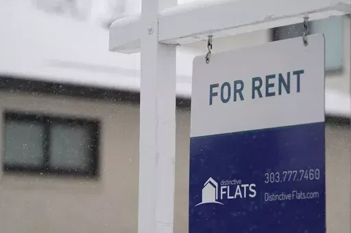 A for rent sign stands outside a single-family home on the market Saturday, Feb. 10, 2024, in Denver. A record number of Americans who rent are now considered cost-burdened, with 30% or more of their income going toward rent and utilities. Companies like Flex, which let you divide your rent into smaller installments via a line of credit or loan, say they’re part of the solution. (AP Photo/David Zalubowski, File)