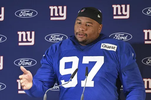 New York Giants defensive tackle Dexter Lawrence II (97) attends a news conference after a practice session in Munich, Germany, Friday, Nov. 8, 2024. The New York Giants are set to play the Carolina Panthers in an NFL game at the Allianz Arena in Munich on Sunday. (AP Photo/Lennart Preiss)