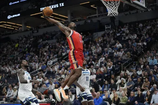 New Orleans Pelicans forward Zion Williamson (1) dunks during the first half of an NBA basketball game against the Minnesota Timberwolves, Wednesday, March 19, 2025, in Minneapolis. (AP Photo/Abbie Parr)