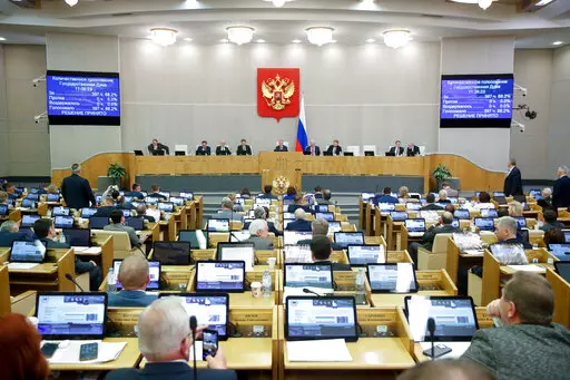 In this handout photo provided by The State Duma, The Federal Assembly of The Russian Federation, Russian lawmakers attend a session of the State Duma, the Lower House of the Russian Parliament in Moscow, Russia, Thursday, Nov. 24, 2022. Russian lawmakers have given their final approval to a bill that significantly expands restrictions on activities seen as promoting LGBTQ rights in the country. (The State Duma, The Federal Assembly of The Russian Federation via AP)