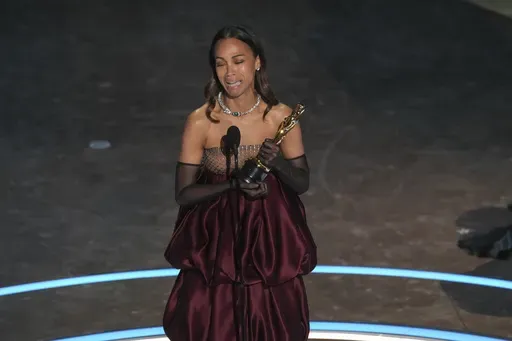 Zoe Saldana accepts the award for best performance by an actress in a supporting role for "Emilia Perez during the Oscars on Sunday, March 2, 2025, at the Dolby Theatre in Los Angeles. (AP Photo/Chris Pizzello)
