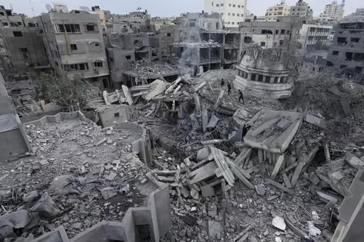 Palestinians inspect the rubble of the Yassin Mosque destroyed after it was hit by an Israeli airstrike at Shati refugee camp in Gaza City, early Monday, Oct. 9, 2023. (AP Photo/Adel Hana, File)