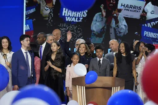 Democratic presidential nominee Vice President Kamala Harris, center, hugs her grand-niece Amara Ajagu surrounded by family during the Democratic National Convention Thursday, Aug. 22, 2024, in Chicago. (AP Photo/J. Scott Applewhite)