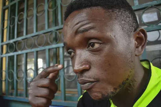 Ateasong Belts Tajoah shows a bullet scar on his neck during an interview with The Associated Press in Dschang, Cameroon, Friday, Dec. 1, 2024. (AP Photo/Robert Bociaga)