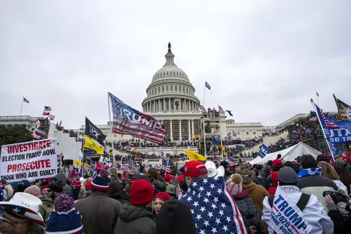 Rioters loyal to President Donald Trump rally at the U.S. Capitol in Washington on Jan. 6, 2021. On Sunday, Jan. 28, 2024, a retired judge recommended to Illinois election officials that former President Trump's name should be removed from the Illinois primary ballot, but the decision should be left to the courts. (AP Photo/Jose Luis Magana, File)