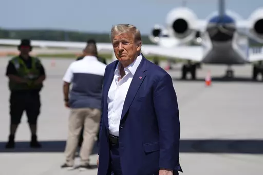Republican presidential candidate former President Donald Trump walks to his vehicle after arriving at the Des Moines International Airport before his visit to the Iowa State Fair, Saturday, Aug. 12, 2023, in Des Moines, Iowa. (AP Photo/Charlie Neibergall)