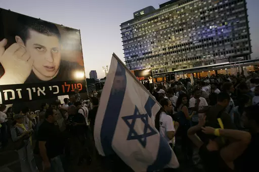 Israelis attend a demonstration calling for the release of abducted Israeli soldier Gilad Shalit, July 22, 2008, in Tel Aviv, Israel. Hamas militants seized Shalit in a cross-border raid on June 25, 2006, killing two other members of his tank crew. Hamas' 2006 seizure of Shalit consumed Israeli society for years — a national obsession that prompted Israel to heavily bombard the Gaza Strip and ultimately release over 1,000 Palestinian prisoners, many of whom had been convicted of deadly attacks